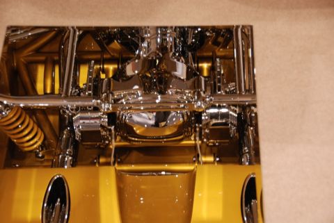 1996 Ford Bronco - Polished chrome suspension and drivetrain components are visible on a gold vehicle.
