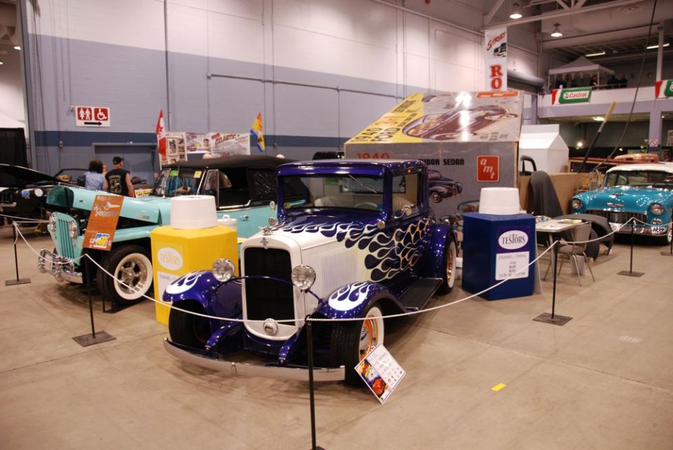 Model kit box for a 1940 Ford Sedan, with other vintage cars in the background