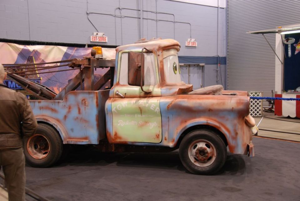 Tow Mater truck with rust and a cartoon face, side view