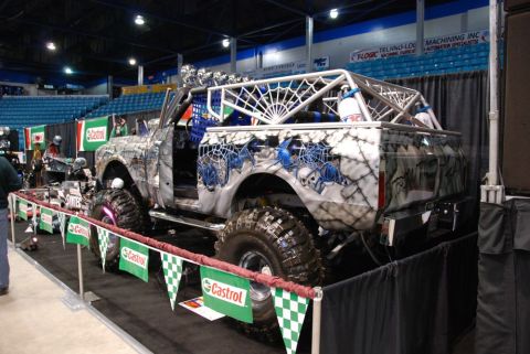 1996 Ford Bronco - This heavily modified SUV features a unique spiderweb and skull graphic paint job and an external roll cage.