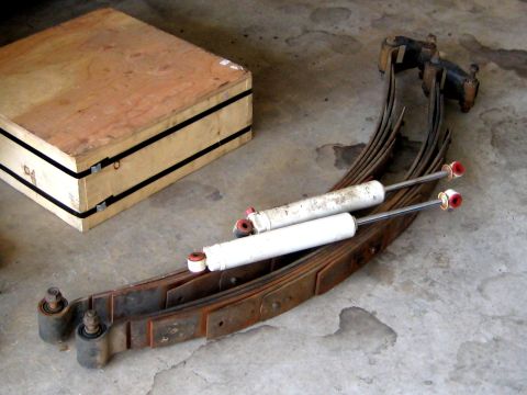 1996 Ford Bronco - Vehicle suspension parts laid out on a concrete surface.