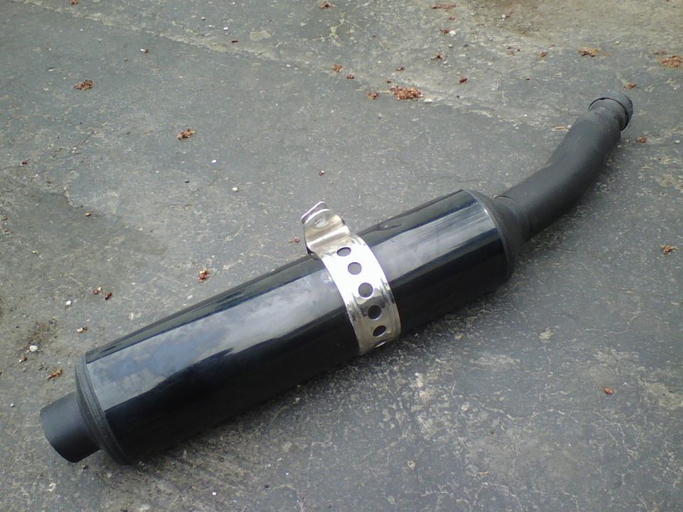 Black motorcycle exhaust pipe with silver clamp