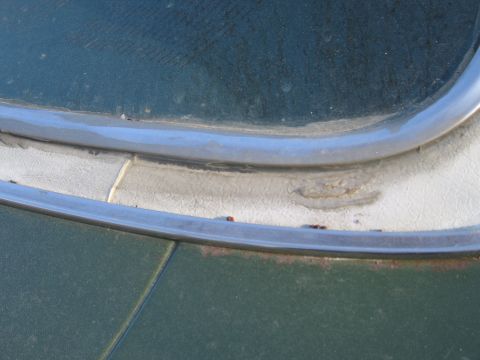 1991 Ford LTD Crown Victoria - Detail shot of aged car trim and paint, revealing signs of wear and minor rust.