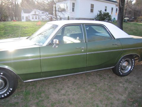 1991 Ford LTD Crown Victoria - This green sedan with a white vinyl roof appears to be from the mid-1970s, not a 1991 model.