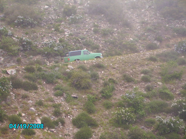 Green 1990 Ford Bronco on a dirt road