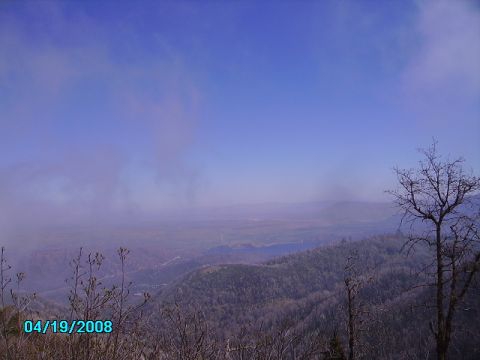 1990 Ford Bronco - A hazy view of rolling hills and distant mountains under a clear blue sky.