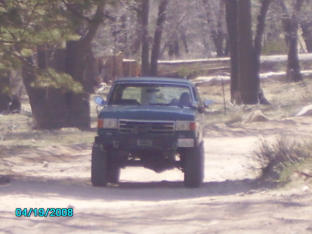 1990 Ford Bronco front view on dirt road