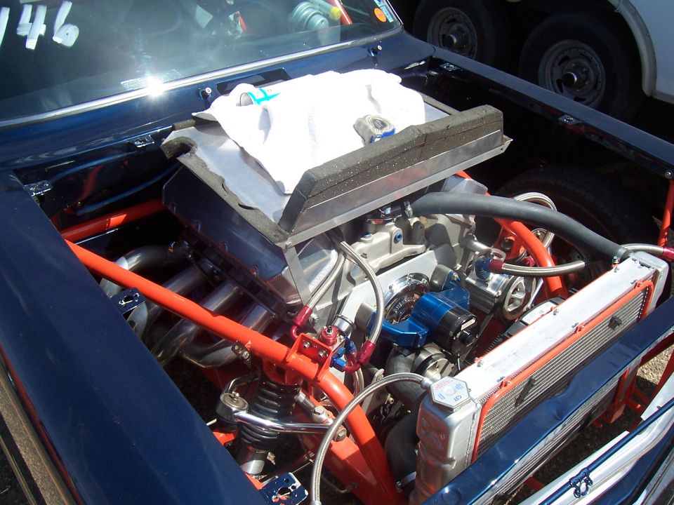 Engine bay with custom modifications and racing roll cage