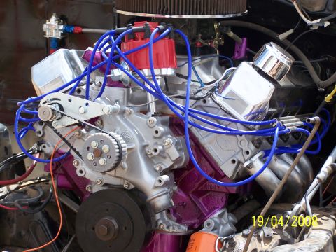 1995 Ford Bronco - Close-up of a modified engine with custom paint and components.