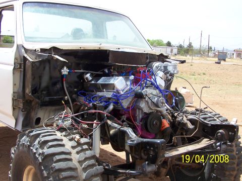 1995 Ford Bronco - This vehicle is undergoing modifications with its engine and front end fully exposed.