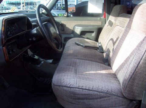 1991 Ford F-150 - The interior of a 1991 Ford F-150 truck is visible, with a focus on the bench seat and dashboard.