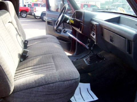1991 Ford F-150 - The interior of a 1991 Ford F-150 pickup truck is visible, with a focus on the driver's seat and dashboard area.