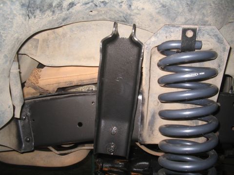 1979 Ford Bronco - Vehicle suspension components including a coil spring and mounting bracket are visible.