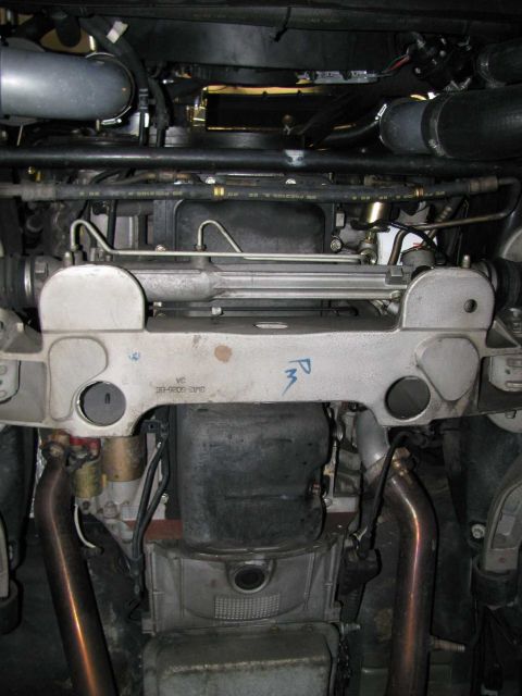 2003 Mercury Marauder - Undercarriage view shows various mechanical components, including exhaust pipes and steering system parts.