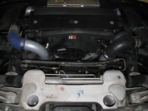 2003 Mercury Marauder - Close-up view of the engine bay, focusing on the intercooler piping and radiator fan assembly.