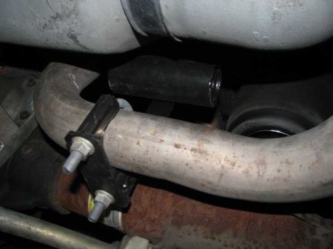 2003 Mercury Marauder - Close-up of the vehicle's exhaust system, showing pipes and a mounting bracket.