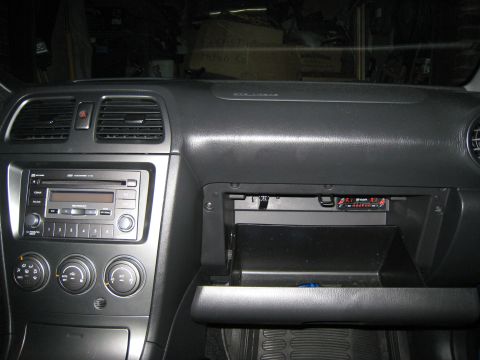 2007 Subaru Impreza - Interior view of a 2007 Subaru Impreza dashboard, including the center console and glove compartment.