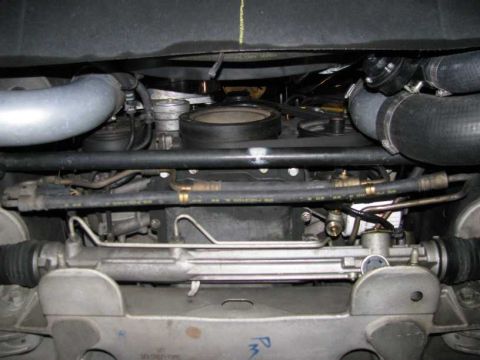 2003 Mercury Marauder - Undercarriage view of a vehicle's engine bay, showing hoses, steering rack, and suspension components.