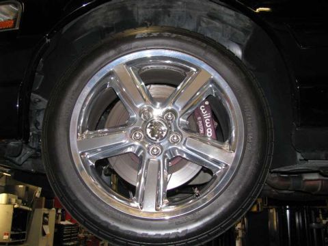 2003 Mercury Marauder - Close-up of the wheel and brake assembly on a 2003 Mercury Marauder, revealing custom performance parts.