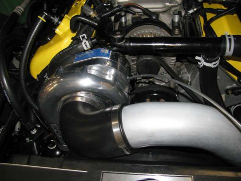 2003 Mercury Marauder - Engine bay detail a polished supercharger and various hoses and belts.