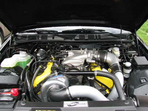 2003 Mercury Marauder - Close-up view of a modified engine bay, showing custom intake and supercharger components.