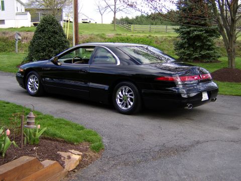 1996 Mercury Grand Marquis - Black 1996 Mercury Grand Marquis coupe parked on a driveway.
