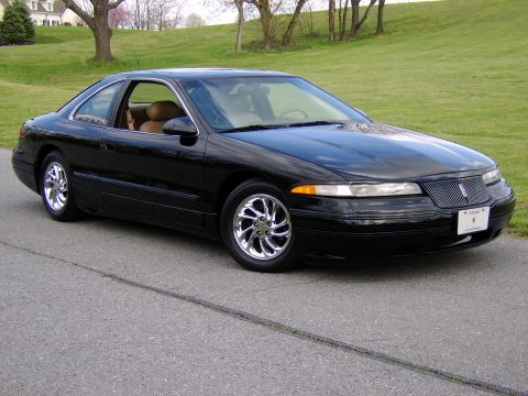 1996 Mercury Grand Marquis - This black coupe features a tan interior and a distinctive grille, seen from a 3/4 front angle.