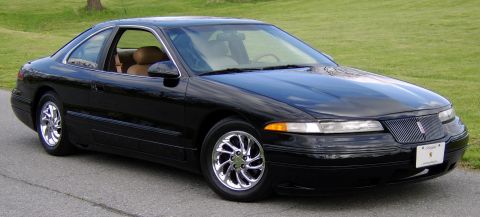 1996 Mercury Grand Marquis - Black coupe with tan interior and chrome wheels parked on asphalt.