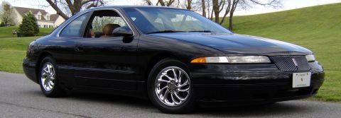 1996 Mercury Grand Marquis - This black coupe, likely a 1995 model, features a distinctive grille and chrome wheels.