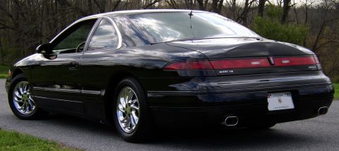 1996 Mercury Grand Marquis - Black Lincoln Mark VIII coupe parked on asphalt with trees in background.