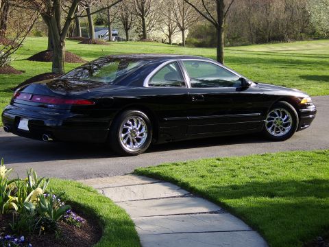 1996 Mercury Grand Marquis - 1996 Mercury Grand Marquis coupe parked on a paved driveway with a stone walkway and grass.