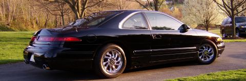 1996 Mercury Grand Marquis - Black coupe with chrome wheels parked on asphalt driveway, another SUV visible in background.