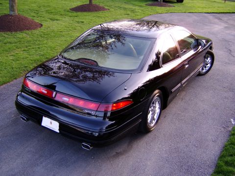 1996 Mercury Grand Marquis - This black coupe features a distinctive rear end with full-width taillights and dual exhaust tips.