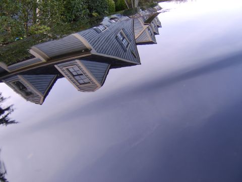 1996 Mercury Grand Marquis - House reflection on car hood.