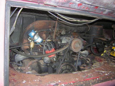 1971 Volkswagen Vanagon - The engine bay of a 1971 Volkswagen Vanagon shows a dirty and aged engine with visible wear and tear.