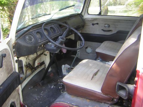 1971 Volkswagen Vanagon - The interior of a 1971 Volkswagen Vanagon reveals its dashboard, steering wheel, and worn seats.