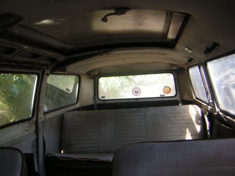 1971 Volkswagen Vanagon - The interior of a 1971 Volkswagen Vanagon shows its age with worn upholstery and a sunroof.