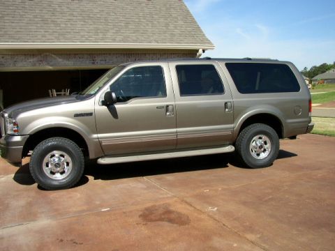 1995 Ford Bronco - This Ford Excursion SUV is a large vehicle with tinted windows and running boards.