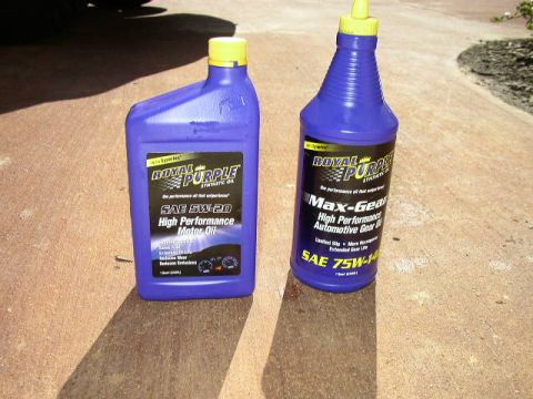 1995 Ford Bronco - Royal Purple synthetic motor oil and gear oil bottles are displayed on a concrete surface.