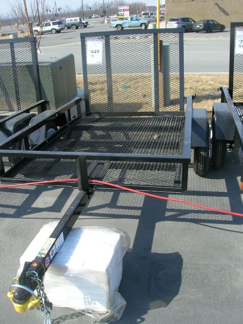 2003 Jeep TJ - A utility trailer is shown from a low angle, with a price tag visible on its side.