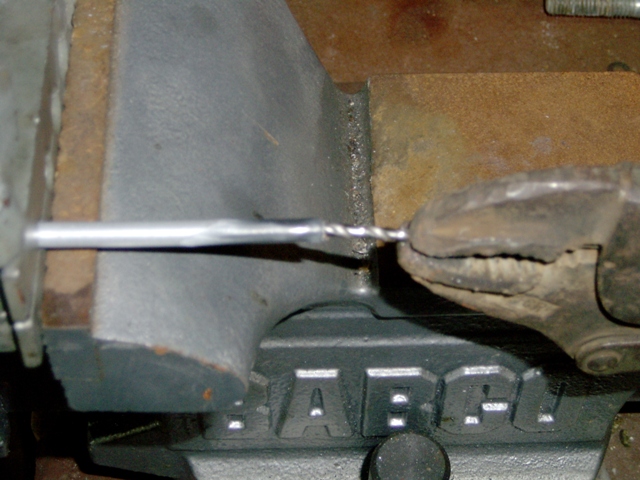 deburring line with 7/64" drill bit, chamfer end with file, put clamp in vise to hold line