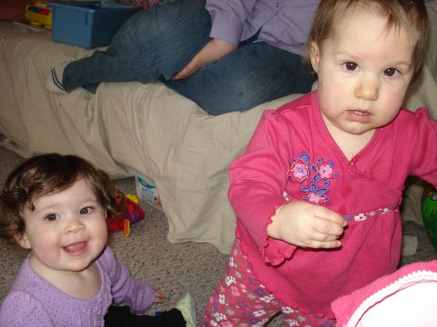 2000 Ford Crown Victoria - Two young children are playing on the floor indoors.