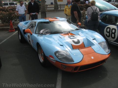 1968 Ford Mustang - A light blue and orange Ford GT40 race car with the number 6 is parked next to another race car.