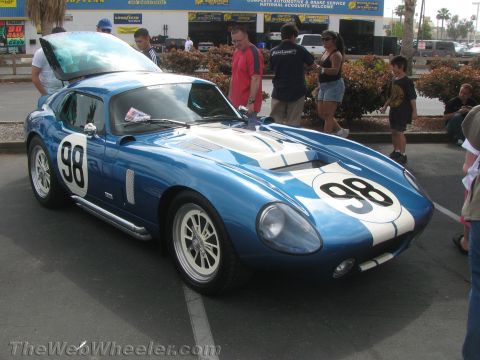 1968 Ford Mustang - A blue Shelby Cobra Daytona Coupe replica is parked outside with its hood open.