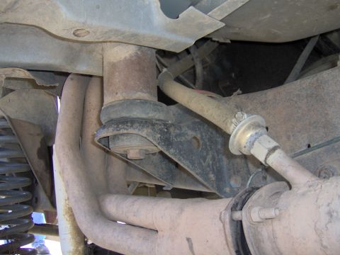 1992 Ford F-350 - Underside view of a truck's exhaust and suspension system, showing signs of wear and tear.