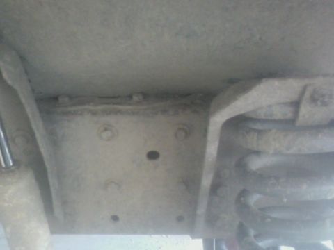 1992 Ford F-350 - Undercarriage view of a truck's frame and suspension system, including a coil spring and shock.