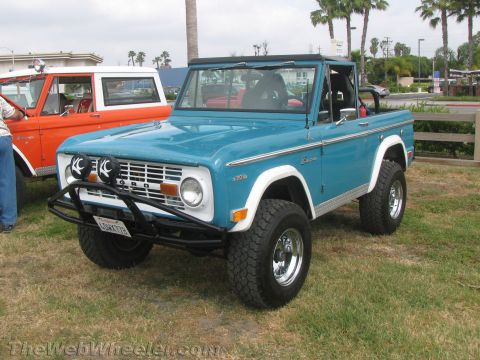 1968 Ford Mustang - A blue 1968 Ford Bronco is parked next to an orange Ford Bronco.