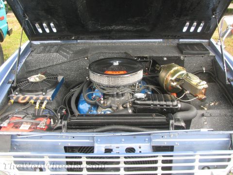 1968 Ford Mustang - Engine bay of a 1968 Ford Bronco, a blue V8 engine and chrome air cleaner.