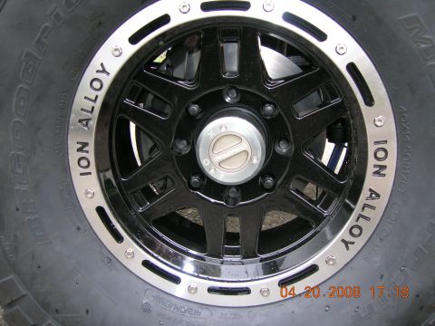 1996 Ford Bronco - Close-up of a black Ion Alloy wheel with a BFGoodrich tire, showing a Dynatrac center cap and a date stamp.
