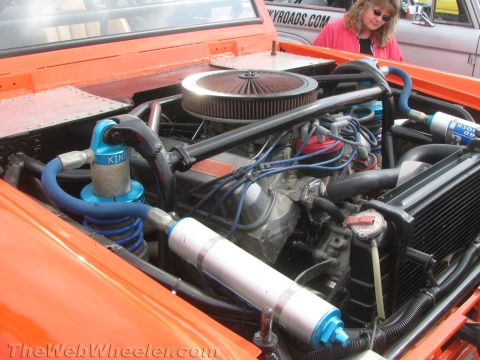 1968 Ford Mustang - Custom suspension components are visible in this engine bay, with a person in the background.